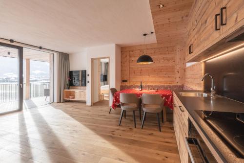a kitchen with a table and chairs in a room at A-Lunis in Brunico