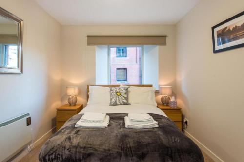 a bedroom with a large bed with two night stands at The Maltings in Edinburgh