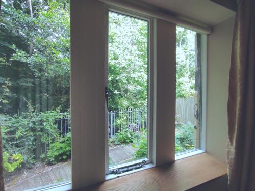 an empty room with a window looking out at a garden at Headingley Hideaway in Headingley