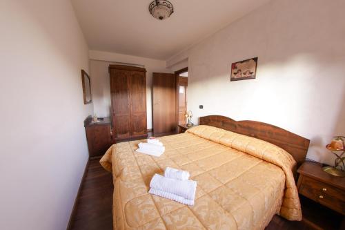 a bedroom with a bed with two towels on it at River Hotel in Castel di Sangro