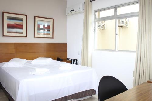 Postel nebo postele na pokoji v ubytování Cyrilo's Palace Hotel