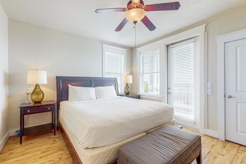 a bedroom with a bed and a ceiling fan at Beach Retreat in Galveston