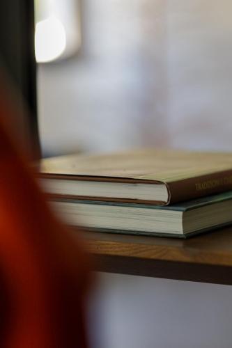 a stack of books sitting on a table at River Hotel in Castel di Sangro