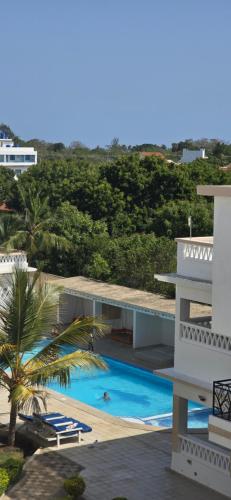 an aerial view of a building and a swimming pool at Villa Becky - Diani Beach in Diani Beach
