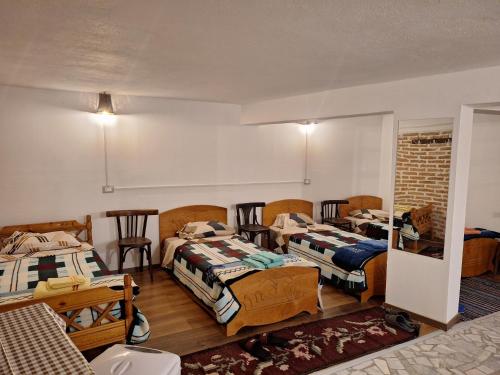 a room with three beds in a room at At Pikotiko's - Korca City Rooms for Rent in Korçë