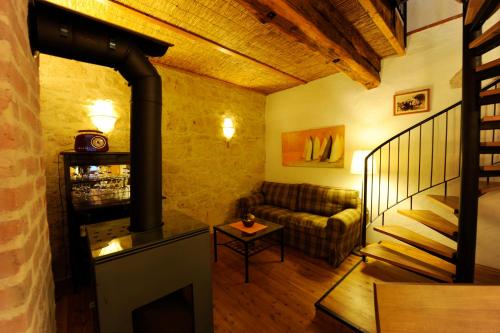 a living room with a couch and a fireplace at Casa.Peiso in Mörbisch am See