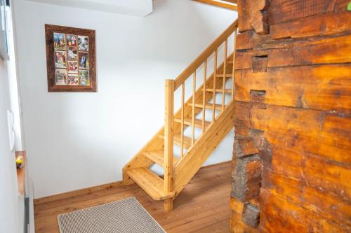 a staircase in a house with a wooden wall at Ferienhaus Sonnseitn in Greifenburg
