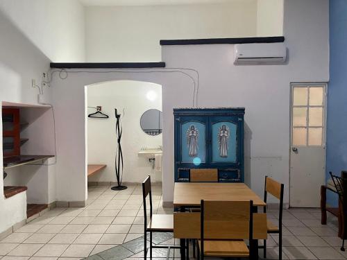 a dining room with a table and a blue cabinet at Hotel Posada Don Matías in Oaxaca City