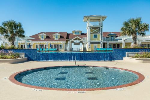 a large swimming pool in front of a house at Beach Retreat in Galveston