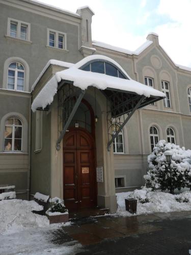 a house with snow on top of it at Pension zur Wartburg in Görlitz