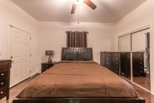 a bedroom with a bed and a ceiling fan at Beautiful Home With Jazucci Tub in New Orleans