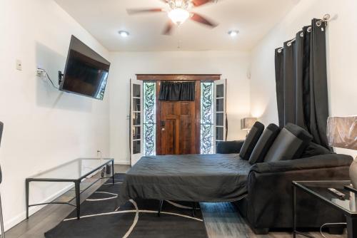 a living room with a bed and a couch at Beautiful Home With Jazucci Tub in New Orleans