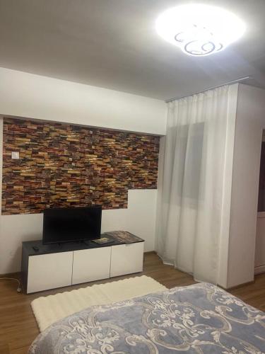 a bedroom with a bed and a brick wall at GD House in Bucharest