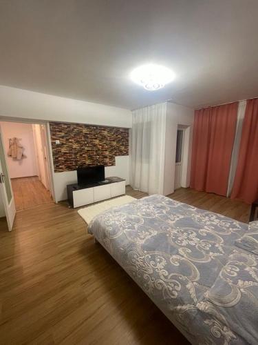 a large bedroom with a bed and a fireplace at GD House in Bucharest