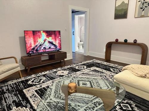 a living room with a flat screen tv on a table at Cedar Street Retreat A Central Downtown in Saint Augustine