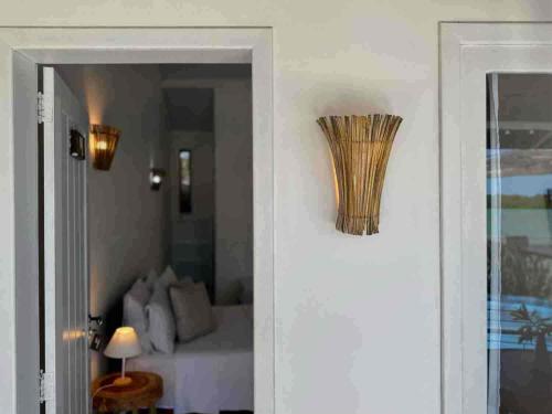 a door leading to a bedroom with a bed at Restaurante & Pousada Gaivota in Santo André