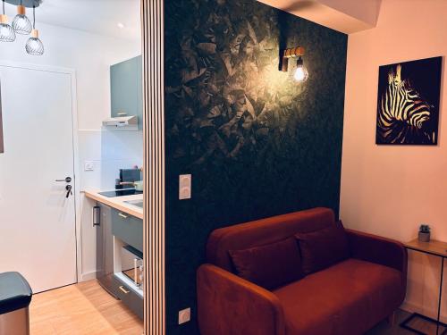 un salon avec une chaise et un miroir dans l'établissement Le Pixie II modern studio easy airport access, à Toulouse