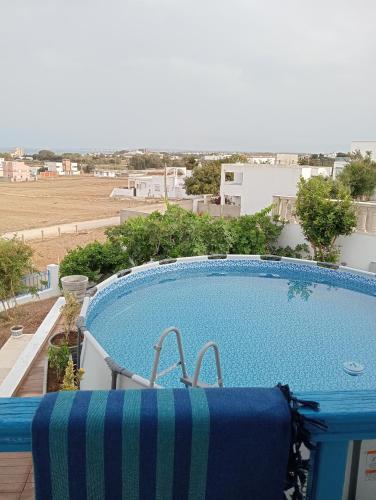 a swimming pool on the roof of a house at Villa Azur Haouaria in Sidi Amor