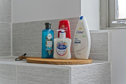 a shelf with two bottles of cleaning products on it at Exquisite 7 Bedroom 5 Bathroom House - Over 1900 sqft - Close to City Centre with Free Parking, Fast W-Fi and SmartTVs by Yoko Property in Northampton