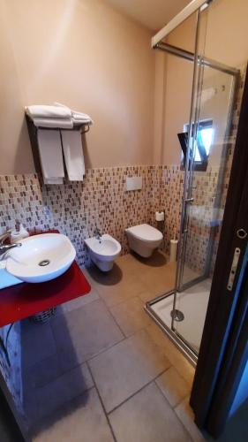 a bathroom with two toilets and a glass shower at Villa Mest Pepp in Monopoli