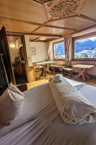 a large bed in a room with a table at Haus Schönjochl by Châtel Reizen in Fiss