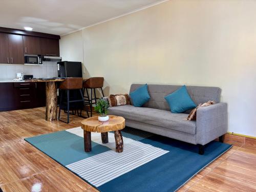 ein Wohnzimmer mit Couch und Tisch in der Unterkunft Cabaña Coyhaique in Coihaique