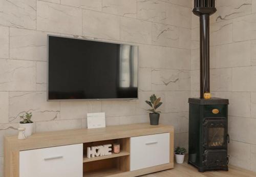 a living room with a tv and a wood stove at House Irena in Pučišća