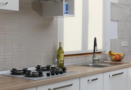 a kitchen counter with a stove and a sink at House Irena in Pučišća