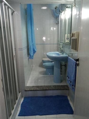 a bathroom with a sink and a toilet and a mirror at Holiday home Carmelo and Daniela in Porto Empedocle