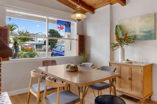 a dining room with a table and chairs and a window at California Dreamin by AvantStay Private Pool Fire Pit Near the Beach in Carlsbad