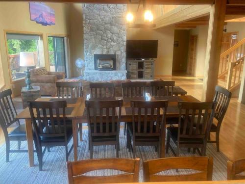 a dining room with a large wooden table and chairs at Beautiful Lake Lodge with Huge Private Dock in Spanaway