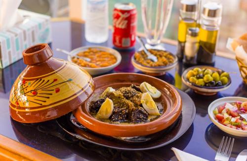 a table with a bowl of food and bowls of food at Mamora Bay in Tangier