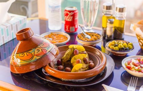 a table with a bowl of food and bowls of food at Mamora Bay in Tangier