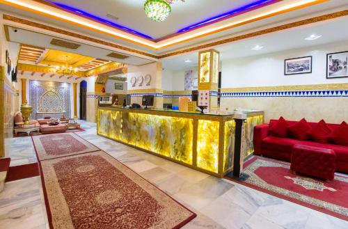 a lobby with a red couch and a gold counter at Mamora Bay in Tangier