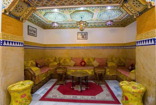 a room with a couch and a table and chairs at Mamora Bay in Tangier