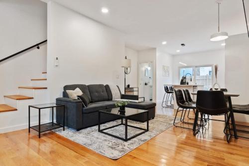 a living room with a couch and a table at 3 BDRM 2 and a Half Bath - House Private Yard Duplex in Pittsburgh