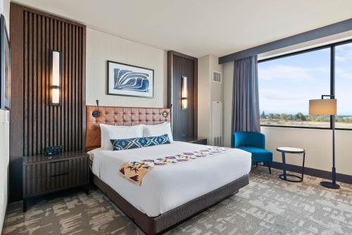 a hotel room with a large bed and a window at Spokane Tribe Resort and Casino in Airway Heights