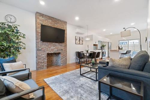 a living room with a couch and a fireplace at Pet Friendly 3 Bdrm House with Private Yard in Pittsburgh
