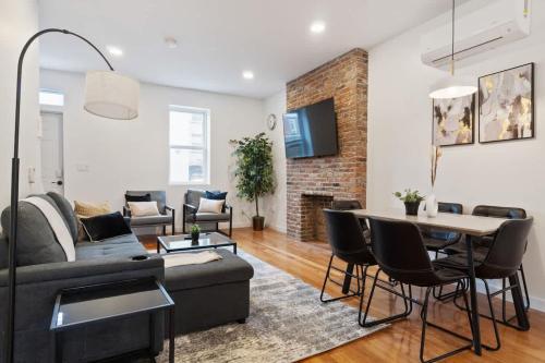a living room with a couch and a table at Pet Friendly 3 Bdrm House with Private Yard in Pittsburgh