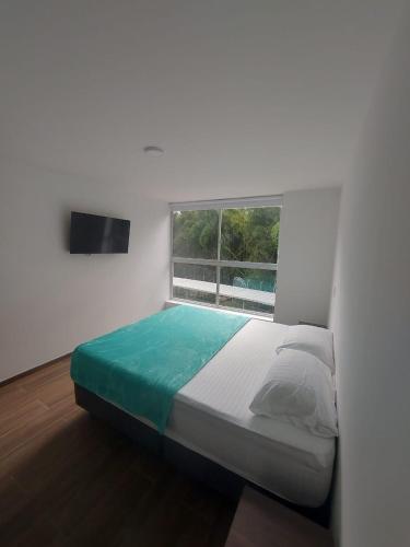 a bed in a room with a window at Apartamento Nuevo en el eje cafetero in Dosquebradas