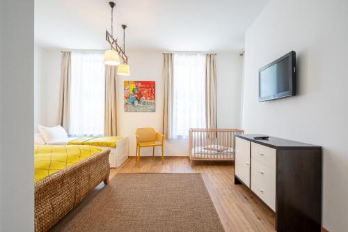 a hotel room with a bed and a tv at Art Apartment Mutters - Innsbruck in Innsbruck