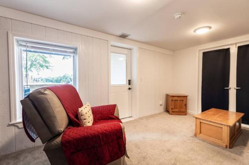 a living room with a red chair and a table at Cool Spring Suite in Arnold