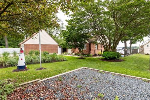 a yard with a lighthouse and a house at Cool Spring Suite in Arnold