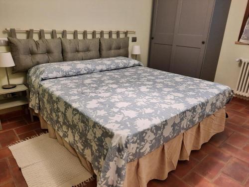 a bedroom with a bed with a blue and white blanket at Casa Cecilia in Novellara