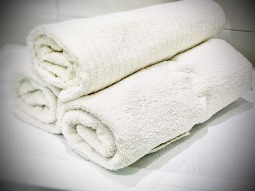 a pile of white towels sitting on a counter at OSapart Apartment in a complex Semycvit in Lviv