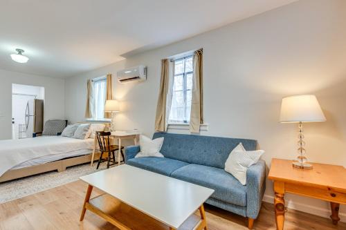 a living room with a blue couch and a bed at Studio Apartment Near East Atlanta Village in Atlanta