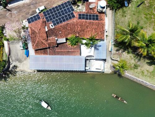 an overhead view of a house with a solar panel in the water at Restaurante & Pousada Gaivota in Santo André
