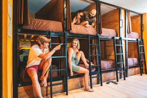a group of people sitting in bunk beds at Wild Rover Huacachina in Ica