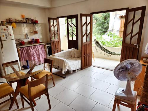 a living room with a table and a refrigerator at Apto Charmoso Santo Antônio in Salvador
