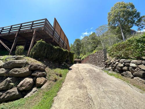 a dirt road next to a stone wall at Inake Lodge in Atuona